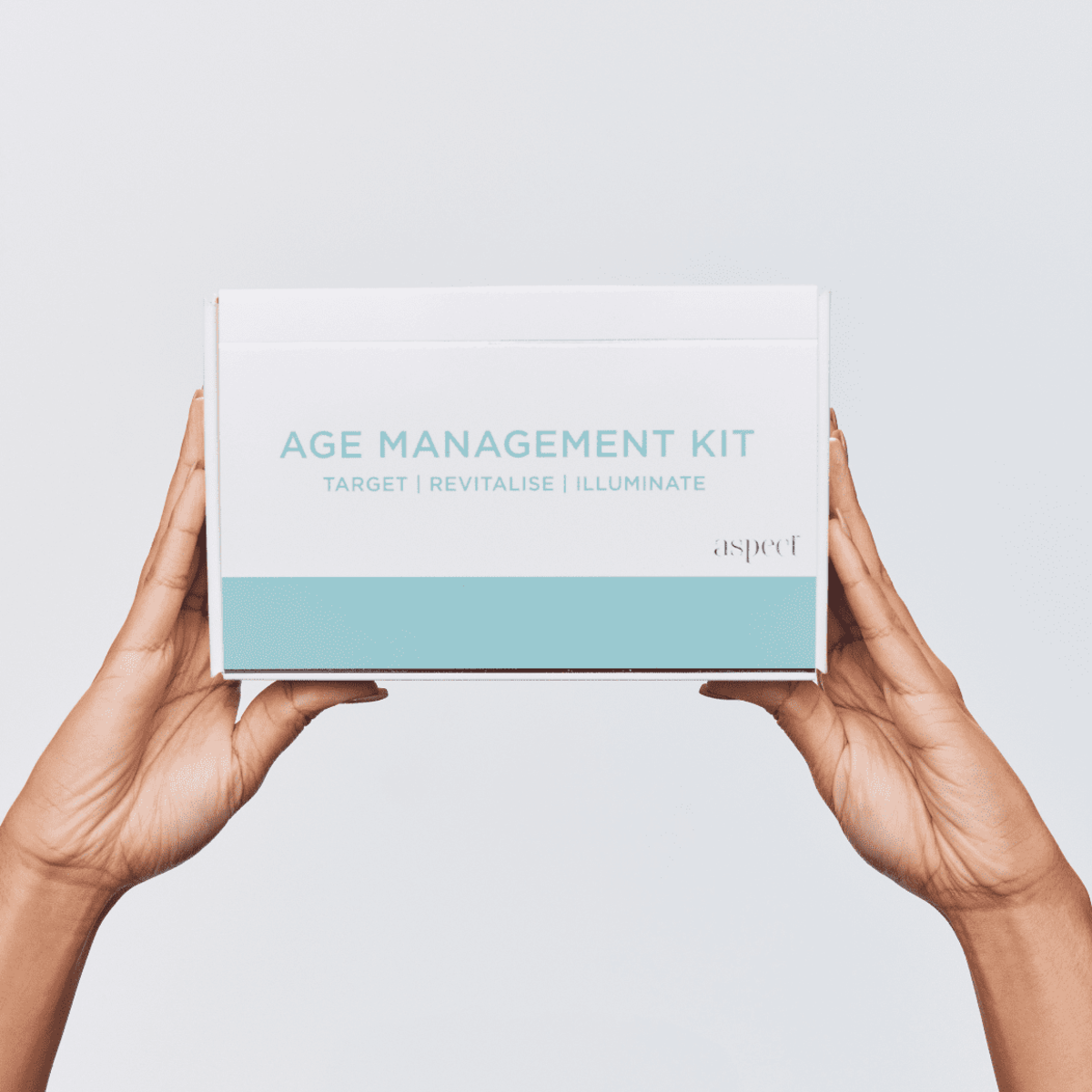 Aspect Age Management Kit box held in two hands, showcasing the full anti-ageing skincare system with cleanser, vitamin C serum, retinol and moisturiser.