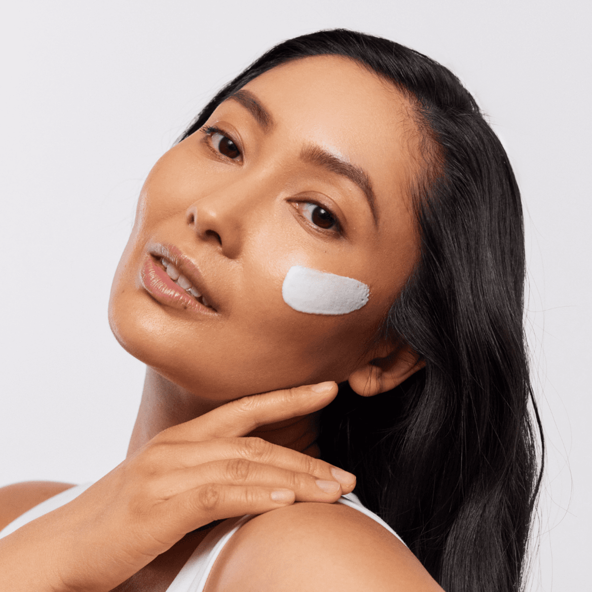 Woman with Aspect Sun Envirostat ‘On The Go’ SPF50+ applied on her cheek, showcasing the lightweight gel texture and fast-absorbing finish.