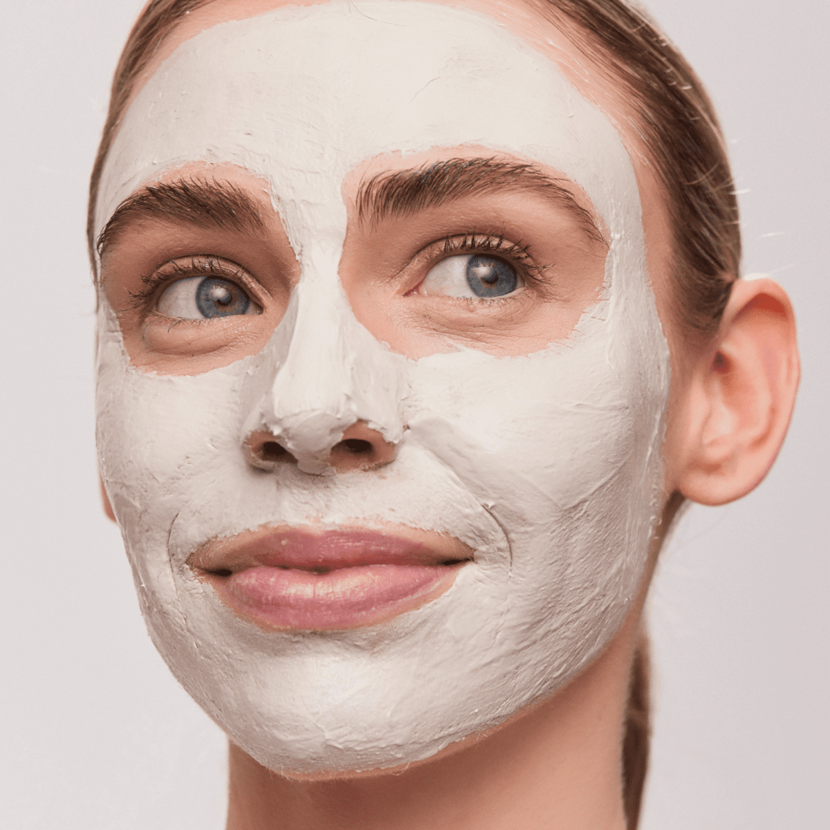 Close-up of woman wearing Aspect Exfoliating Clay Mask, showcasing the detoxifying kaolin and salicylic acid formula that clears congestion and smooths skin.