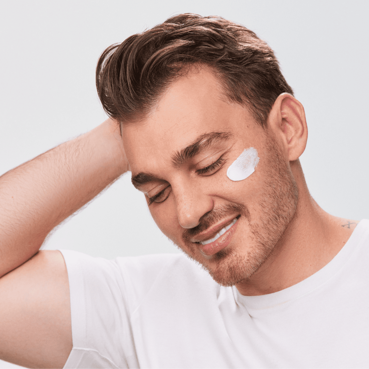 Man with Aspect Hydra Shield applied to his face, showcasing the soothing, antioxidant moisturiser that hydrates and shields skin from environmental stress.