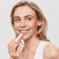 Woman holding Aspect Hydrating Lip Balm, highlighting the moisturising formula enriched with shea butter, coconut oil and vitamin E for soft, healthy lips.