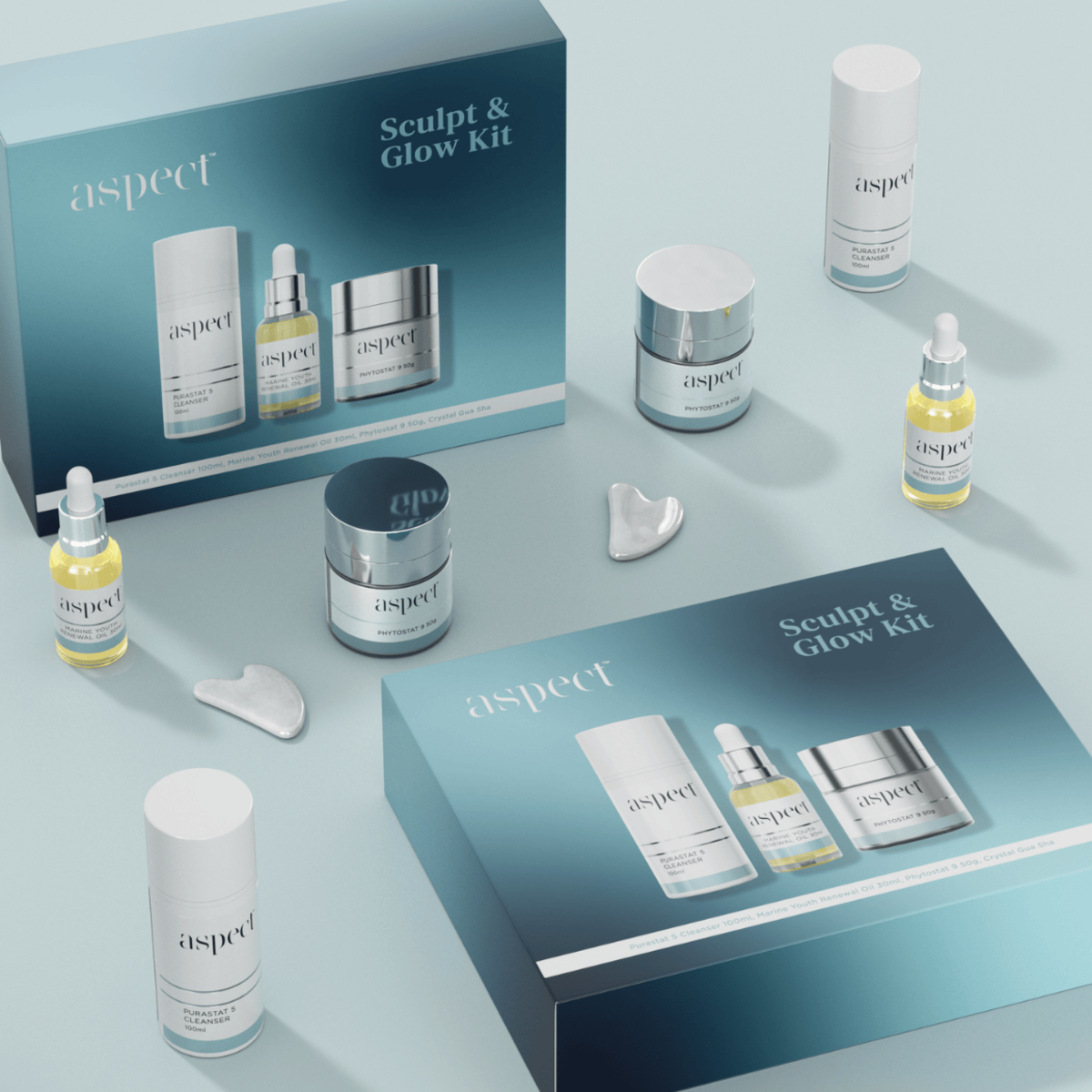 Styled flatlay of two Aspect Sculpt & Glow Limited Edition Kits with boxes and skincare items arranged together for a luxurious hydrating and sculpting skincare ritual.