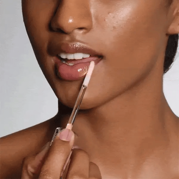 Cosmedix Lumi Crystal Liquid Crystal Lip Hydrator layered onto lips for a glossy, visibly plumped finish.
