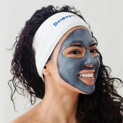 Woman with Dp Dermaceuticals CLR Clarifying Mask applied evenly across her face, demonstrating texture, coverage and how to use the purifying treatment.