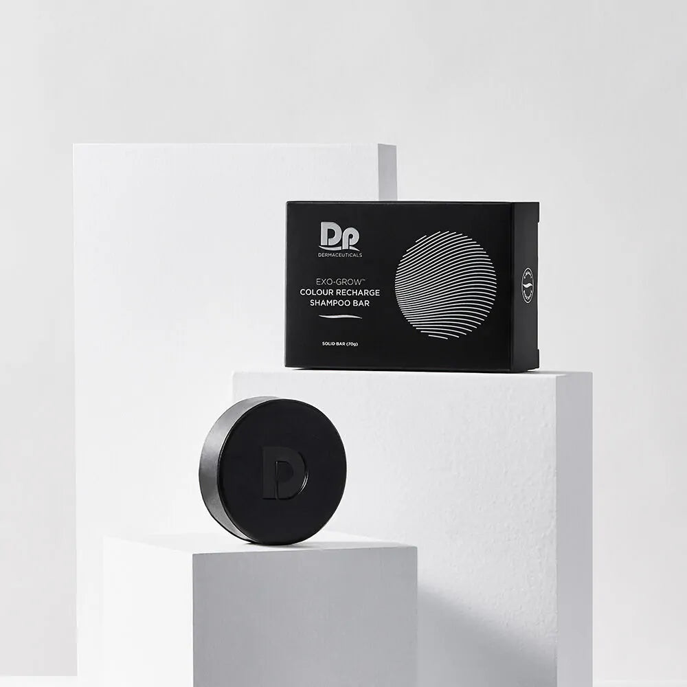 Styled display of the DP Dermaceuticals EXO-GROW Colour Recharge Shampoo Bar and packaging, highlighting its grey-reducing, colour-restoring and scalp-supporting formula.
