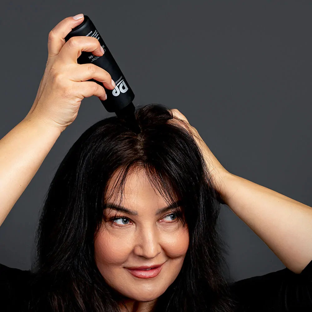 Woman applying DP Dermaceuticals EXO-GROW Scalp Mask to the scalp, demonstrating targeted exfoliation and detoxifying treatment for thinning or congested hair.