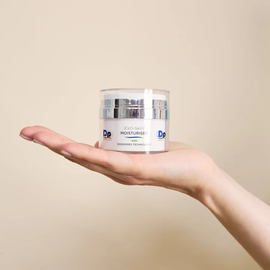 Woman’s hand holding Dp Dermaceuticals Exo-Skin Moisturiser, demonstrating size and premium skincare presentation.
