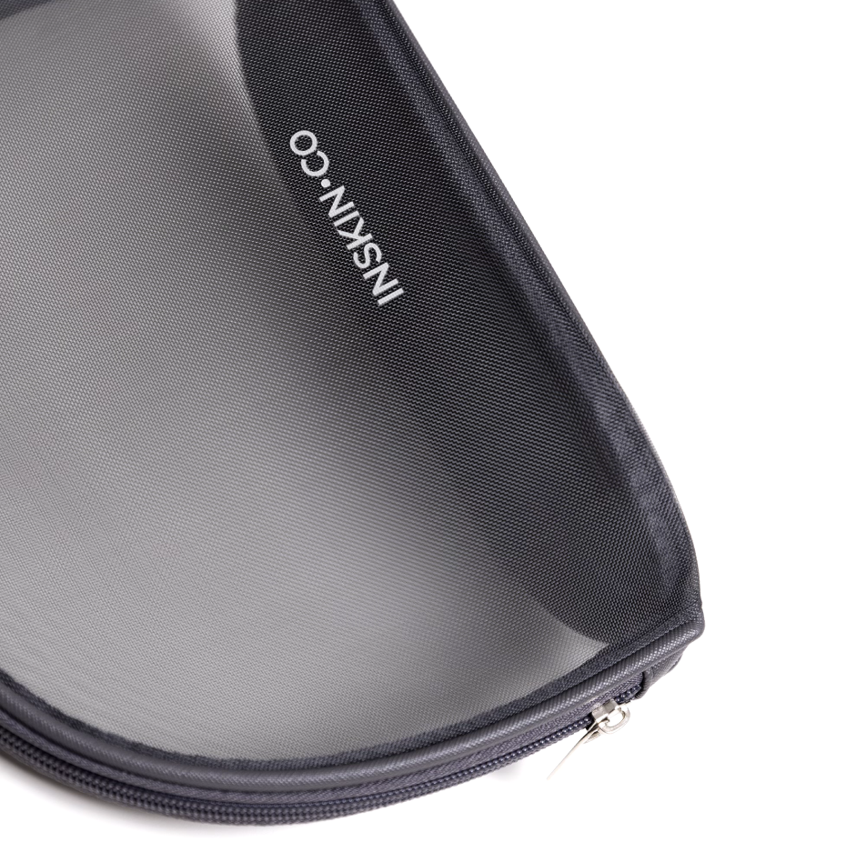 INSKIN.CO Clear Skin Kit branded mesh travel pouch designed to store acne-focused skincare products for travel and daily routines.