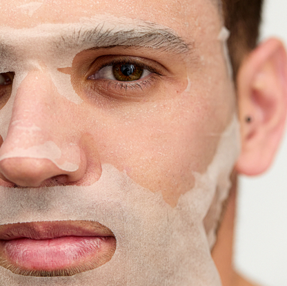 Man wearing INSKIN.CO Calm & Soothe Daily Sheet Mask on face highlighting calming, hydrating treatment for redness-prone skin.