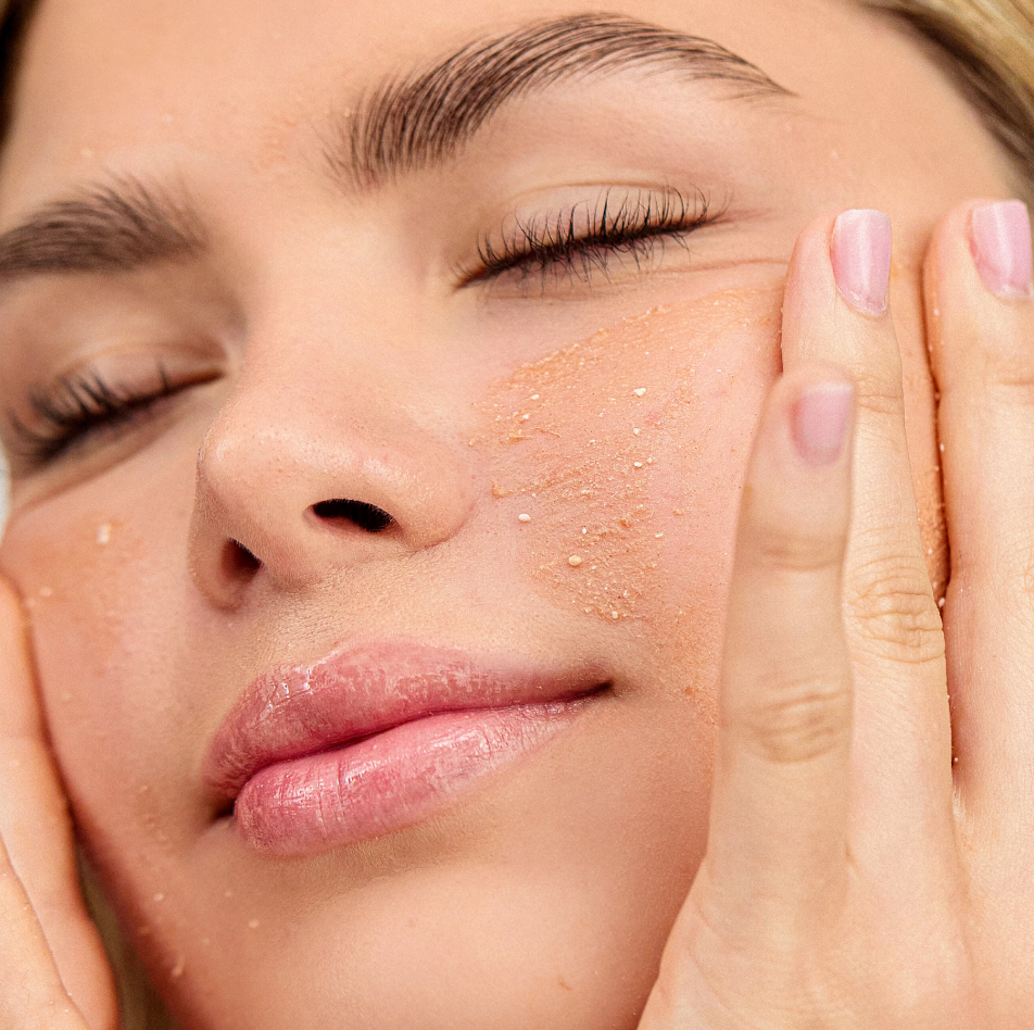 Woman cleansing face with INSKIN.CO Powder Cleanser & Exfoliant showing gentle exfoliating foam and refined skin texture.
