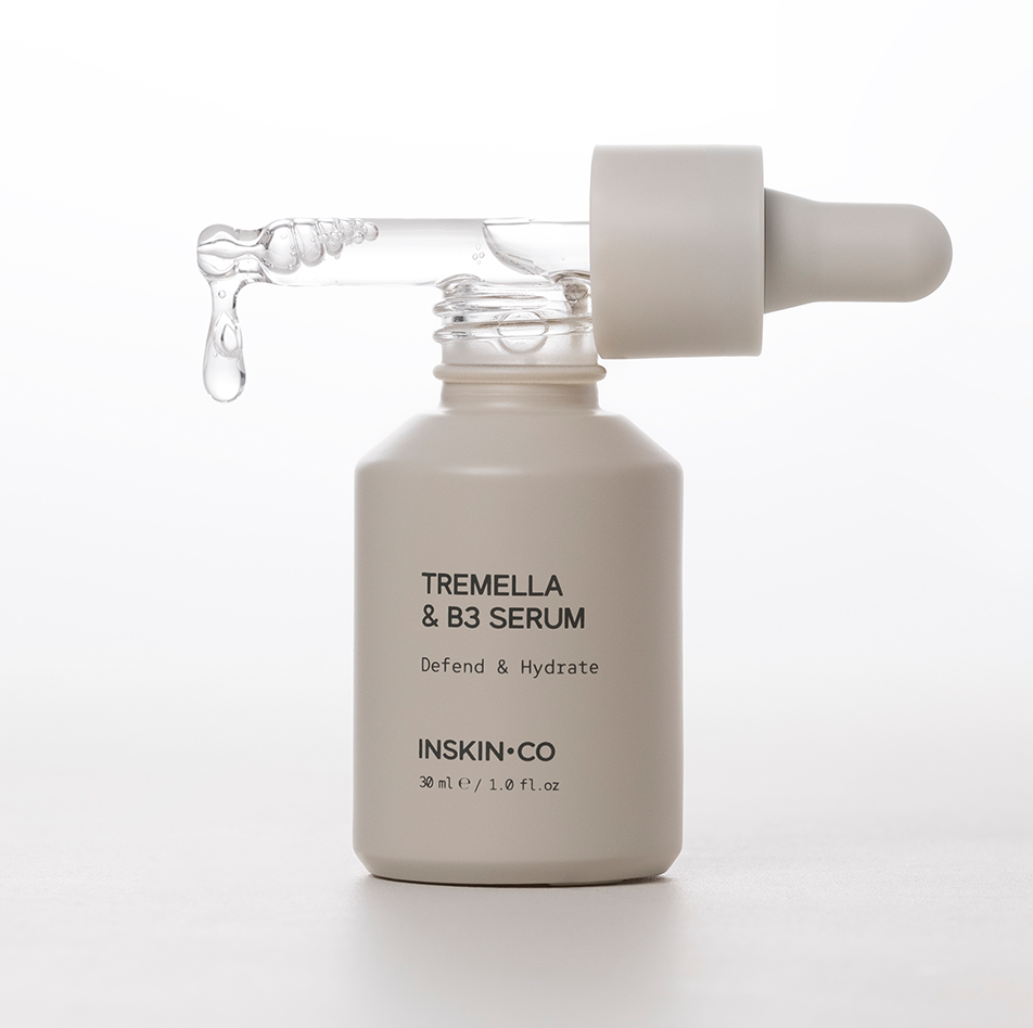 INSKIN.CO Tremella & B3 Serum open bottle with dropper resting across opening showcasing tremella mushroom and niacinamide serum texture.