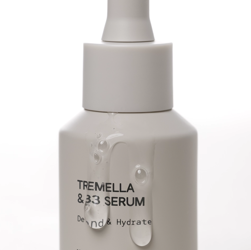 INSKIN.CO Tremella & B3 Serum close up with hydrating serum dripping down bottle highlighting silky texture and moisture retention.