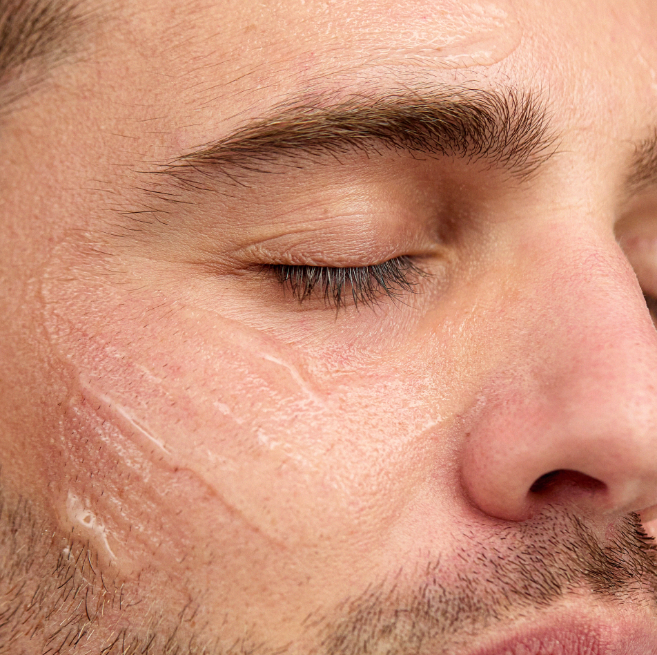 Man applying INSKIN.CO Vitamin D & B5 Serum to face showing lightweight calming serum for skin barrier repair.