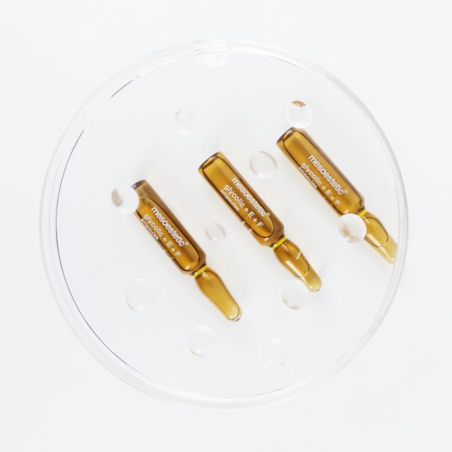 Mesoestetic Glycolic + E + F Ampoules shown in trio, an exfoliating ampoule treatment for dull skin, uneven texture and visible imperfections.
