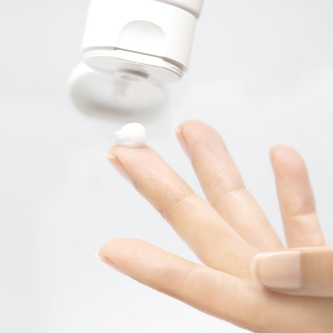 Mesoestetic Hydracream Fusion being dispensed onto fingertips, a gentle nourishing cleanser for dry and sensitive skin that helps cleanse without stripping.