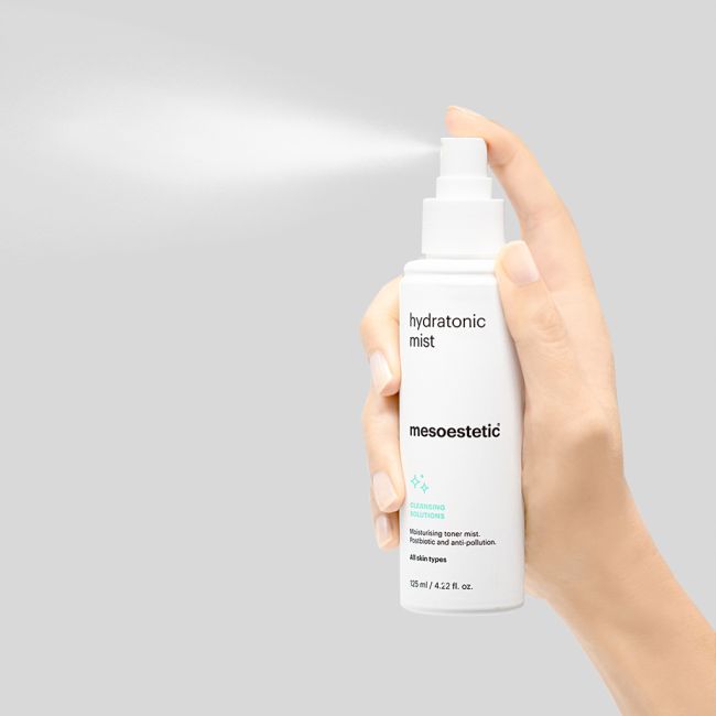 Mesoestetic Hydratonic Mist being sprayed from the bottle, a moisturising facial mist that helps soothe, hydrate and rebalance the skin.