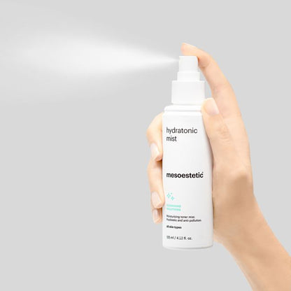 Mesoestetic Hydratonic Mist being sprayed from the bottle, a moisturising facial mist that helps soothe, hydrate and rebalance the skin.