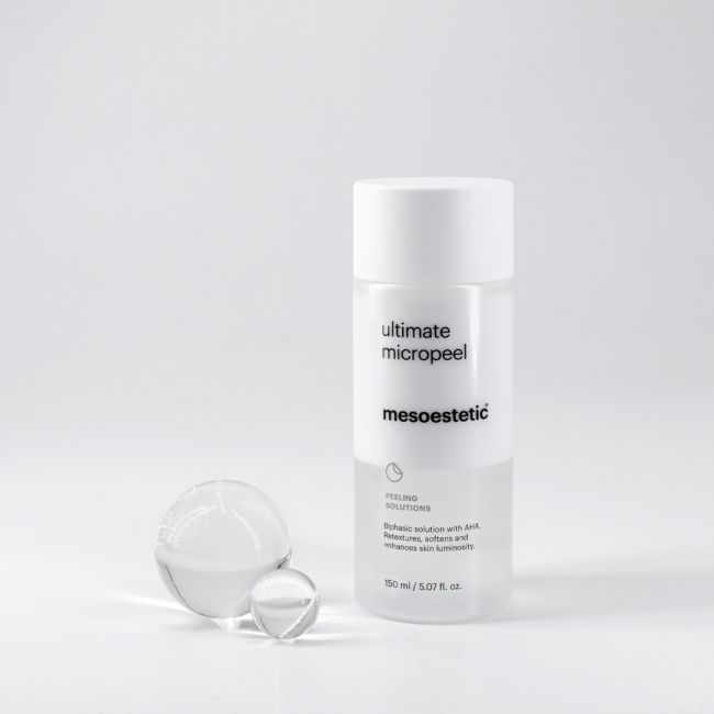 Mesoestetic Ultimate Micropeel exfoliating treatment displayed with glass spheres, designed to retexture skin, smooth imperfections and enhance luminosity.