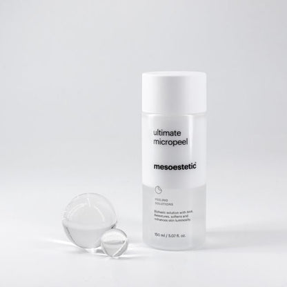 Mesoestetic Ultimate Micropeel exfoliating treatment displayed with glass spheres, designed to retexture skin, smooth imperfections and enhance luminosity.