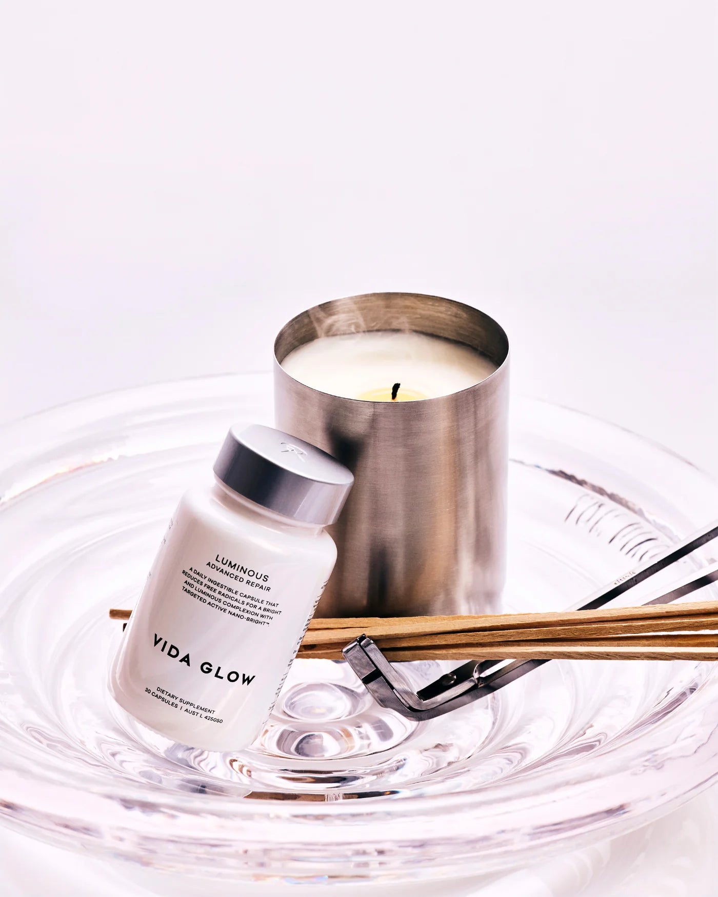 Vida Glow Advanced Repair Luminous styled in a premium beauty setting to reflect daily ingestible support for brighter, more radiant-looking skin.