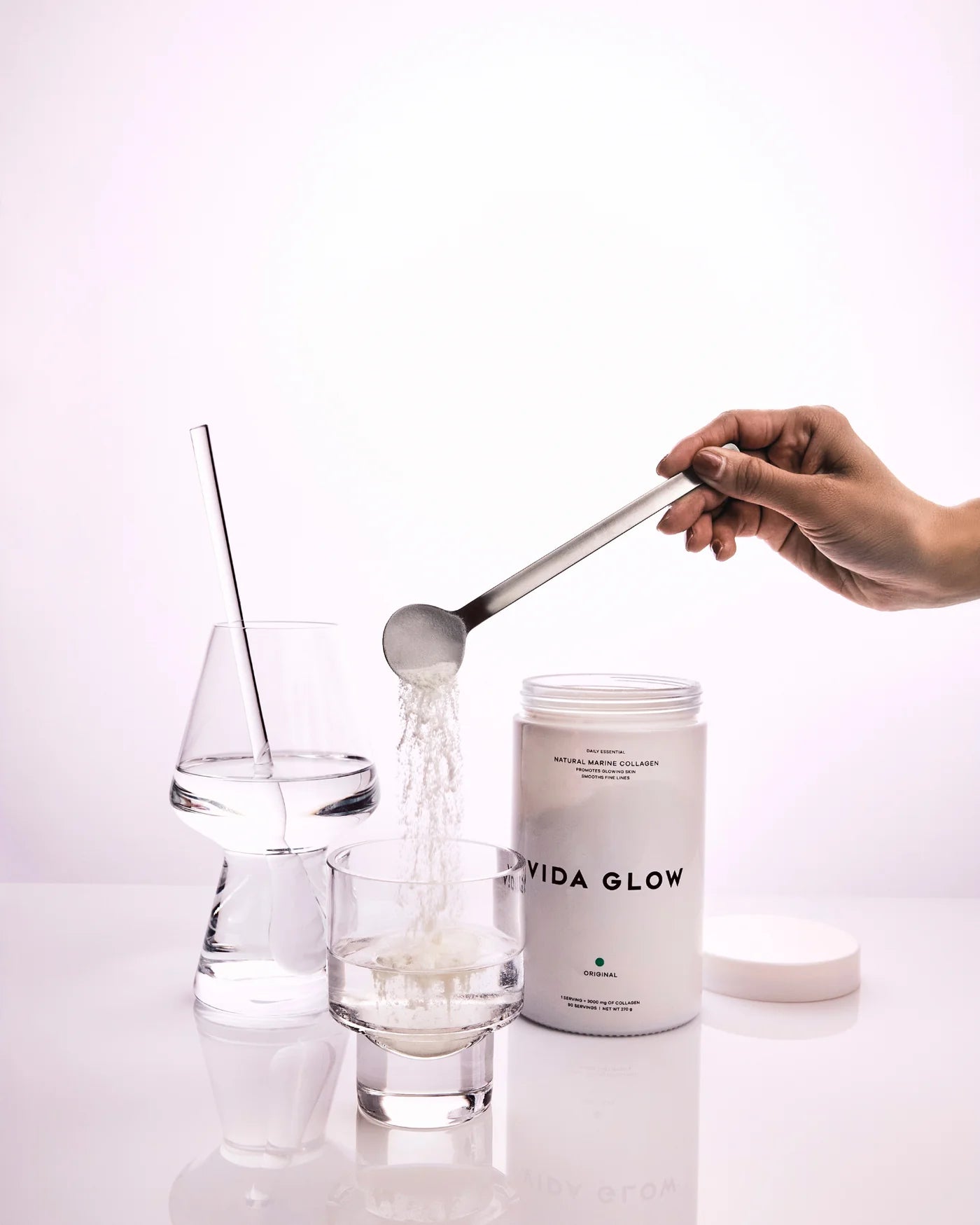 Vida Glow Natural Marine Collagen Powder Glass Tub Original mixed into water for an easy daily collagen routine supporting skin, hair and nails.